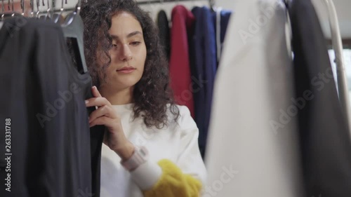 Wallpaper Mural Girl runs across racks of clothes in a store. Torontodigital.ca