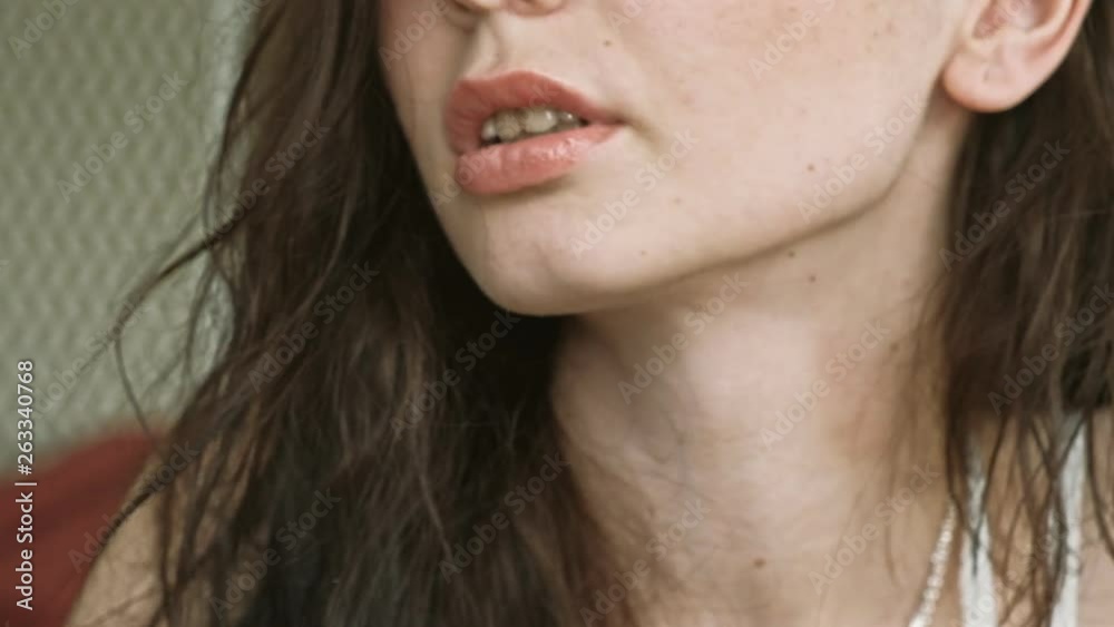 Very closeup shooting of ypung long haired female with fresh lips and shining eyes in cafe Very closeup shooting of ypung long haired female with fresh lips and shining eyes in cafe