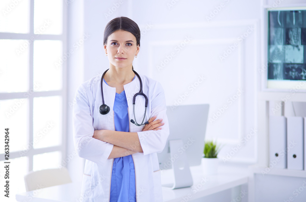 Young smiling female doctor with stethoscope at doctor's office Young smiling female doctor with stethoscope at doctor's office