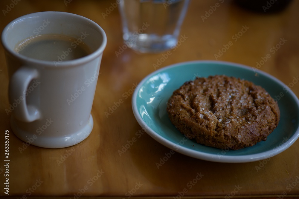 cup of coffee and cookies on wooden table cup of coffee and cookies on wooden table