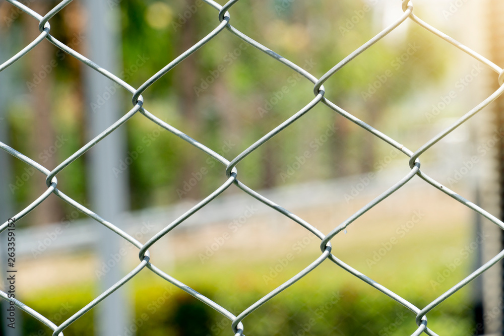 Fototapeta premium The steel cage crosses and has a natural background.