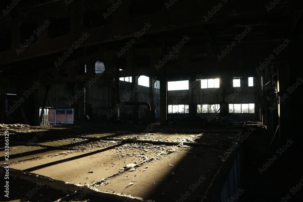 abandoned industrial factory workshop in the light of the evening sun