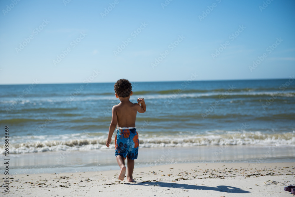 little boy playing on the beach