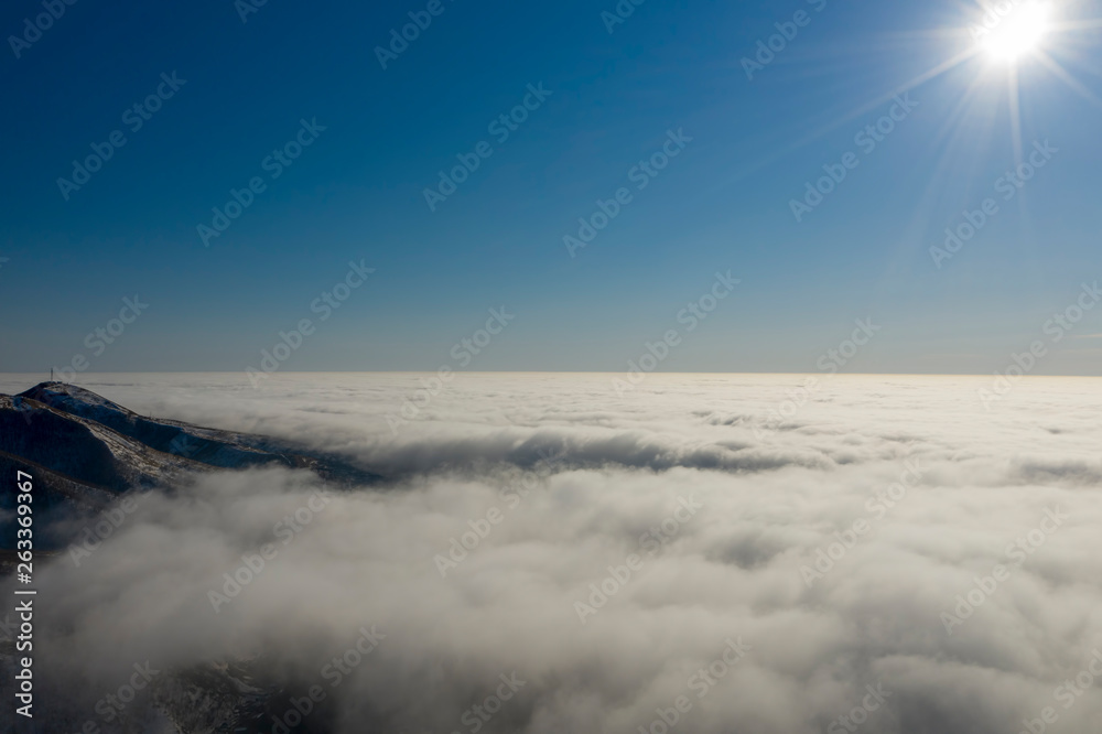 Rare early morning winter fog over the city skyline of the sea bay and skyscrapers before sunrise.