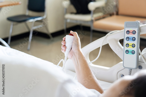 View of patient press red emergency button to calling nurse for help in hospital.
