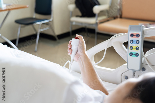 View of patient press red emergency button to calling nurse for help in hospital.