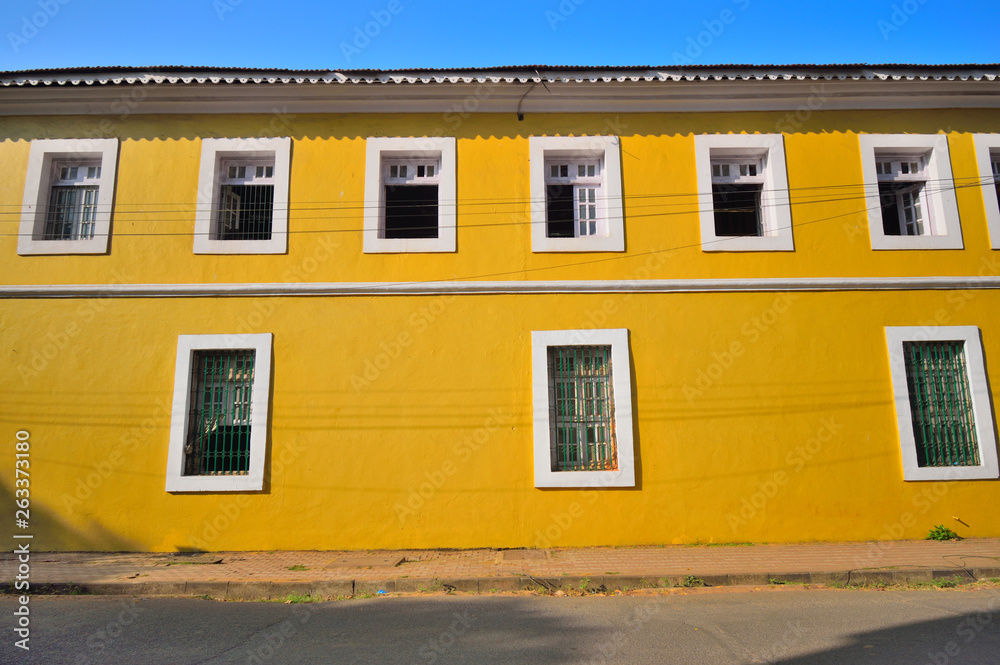 An old, yellow Portuguese building in the street in Panaji, Goa.
