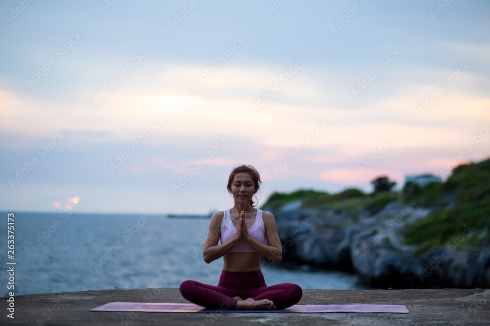 happy healthy women practicing yoga. sitting in lotus pose meditation outdoors concentrating breathing asana yoga.Easy Pose. .beautiful landscape view sky on evening sunset nature evening outdoor. happy healthy women practicing yoga. sitting in lotus pose meditation outdoors concentrating breathing asana yoga.Easy Pose. .beautiful landscape view sky on evening sunset nature evening outdoor.