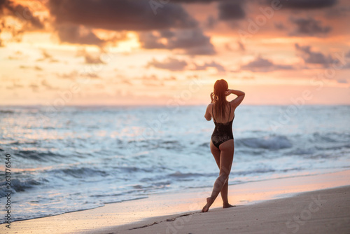 Woman Enjoying Beautiful Sunset on the Beach