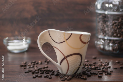 Coffe Cup with Spreading Coffee Beans and Coffee Container