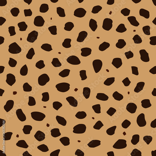Cheetah skin with stains as a seamless pattern, spots are scattered in a chaotic manner, a trendy background for a fabric or a cover on the theme of African animals