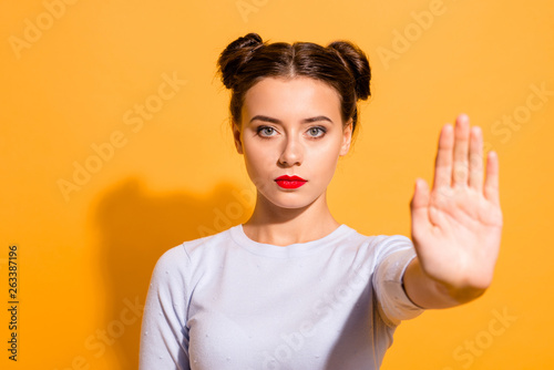 Close-up portrait of her she nice cute attractive lovely winsome candid decisive teen girl showing stop sign palm refuse offer isolated over bright vivid shine yellow background