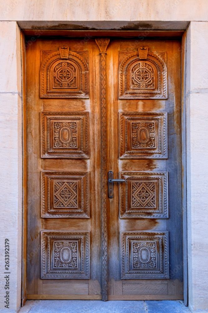 Vintage wood background with carving. Fragment of carved  door in Church, Greece.