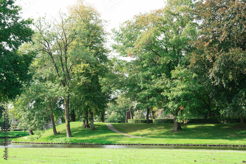 Fototapeta Naklejka Na Ścianę i Meble -  green park with trees, grass, pond in fortified city Elburg, The Netherlands