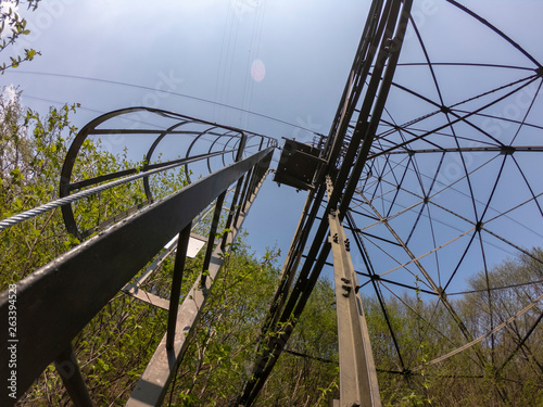 The pylon of the cableway that connects the towns of Albino and Selvino. Green painted pylons to camouflage them in the woods