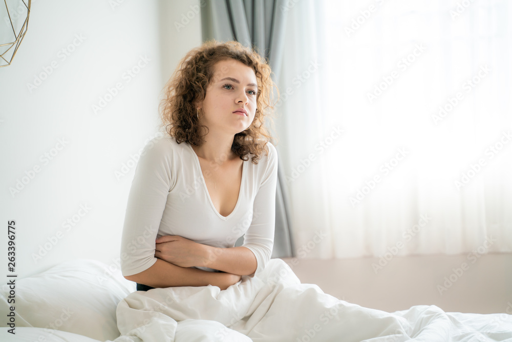 Caucasian women stomachache wake up on bed Caucasian women stomachache wake up on bed