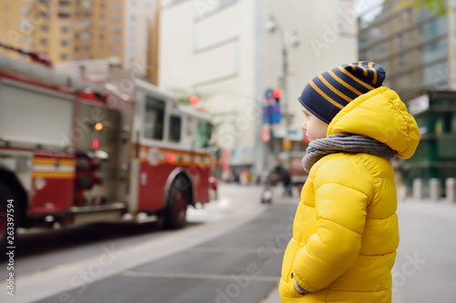 Little boy looks on fire engine. New York, USA. photo