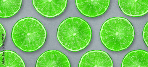 Sliced juicy lime on a gray background. Fresh fruits. Fruit background. Summer party. Birthday.