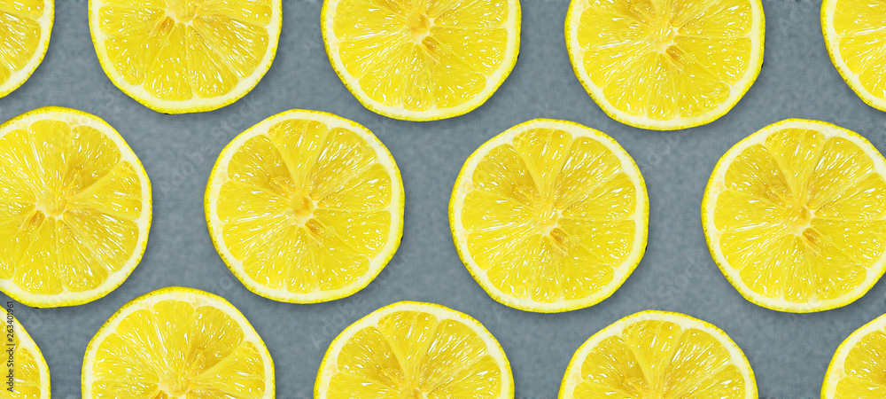 Sliced juicy lemon on a gray background. Fresh fruits. Fruit background. Summer party. Birthday.