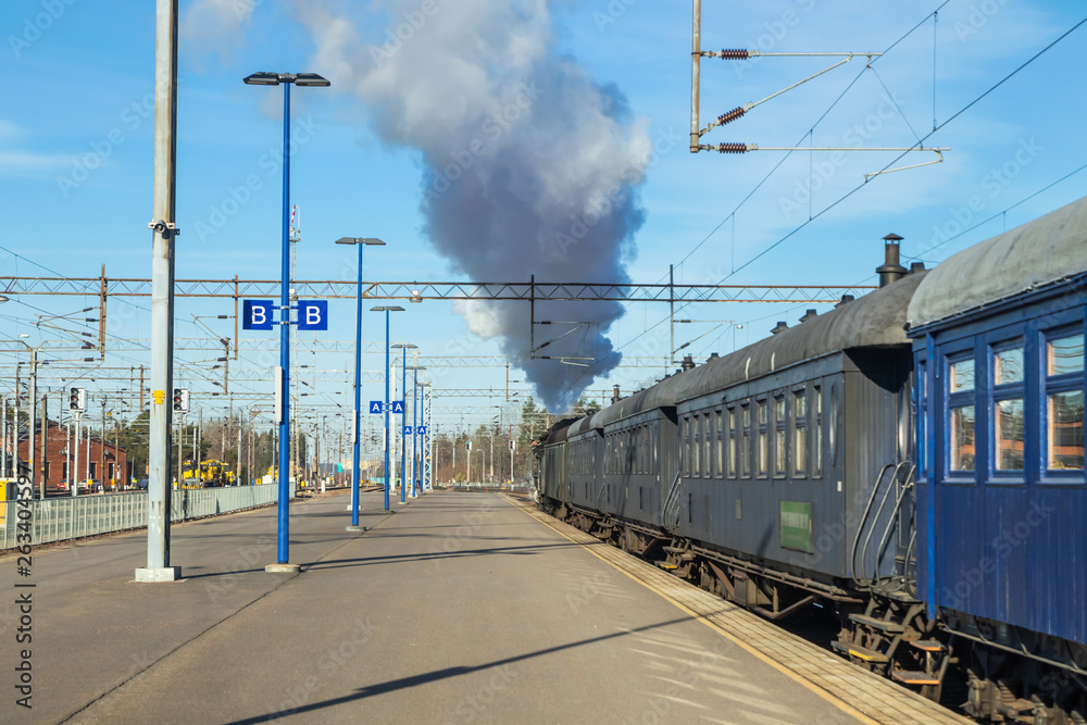 Kouvola, Finland - April 18, 2019: Old steam train Ukko-Pekka is leaving the station at morning.