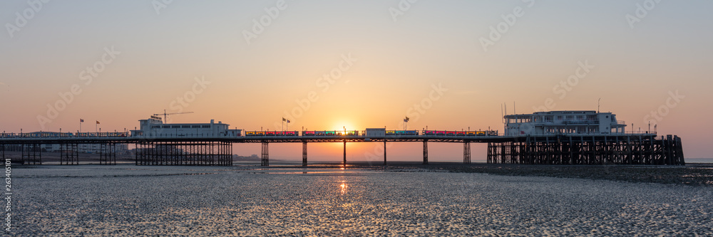 Dawn With Sun Rising Behind Worthing Pier at Low Tide Dawn With Sun Rising Behind Worthing Pier at Low Tide