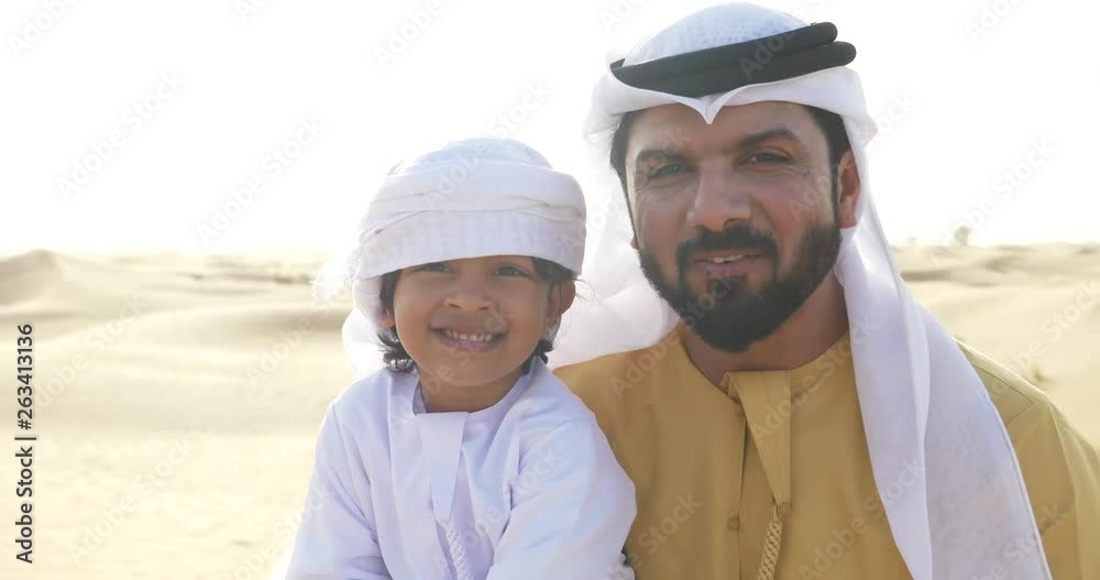 Father and son having fun in the Dubai desert Father and son having fun in the Dubai desert