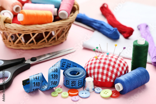 Sewing accessories on pink background