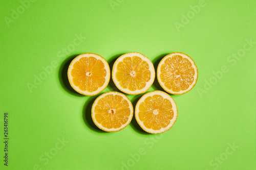 Lemon on green background. Flat lay  top view  copy space . Food concept.