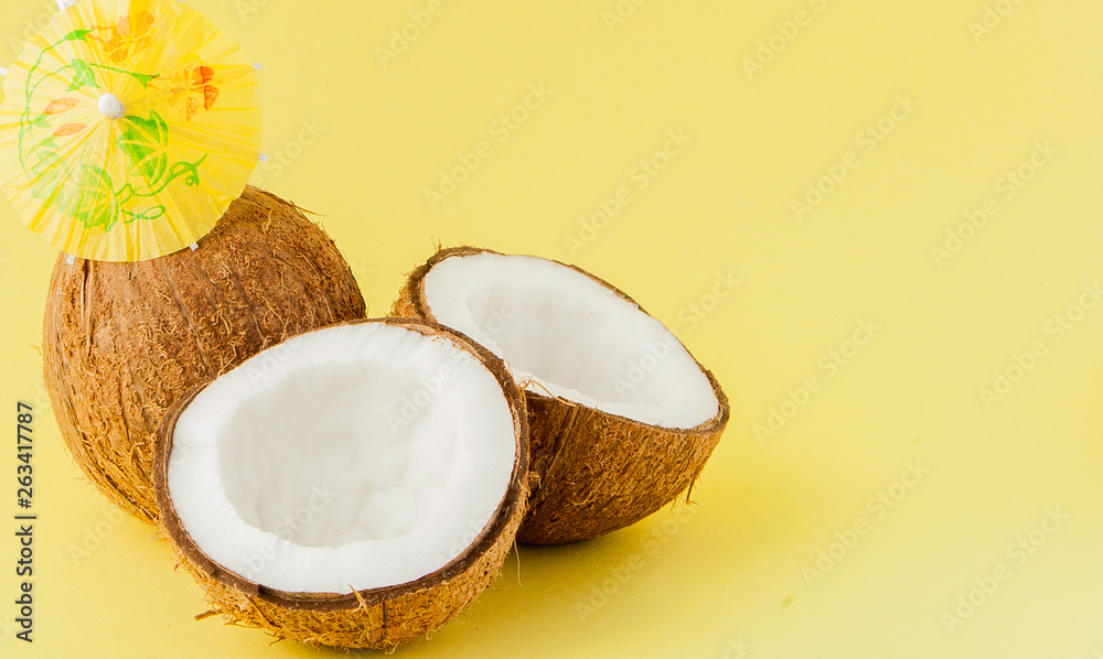 Fresh Coconut cocktail with a straws on yellow background, copy space Fresh Coconut cocktail with a straws on yellow background, copy space