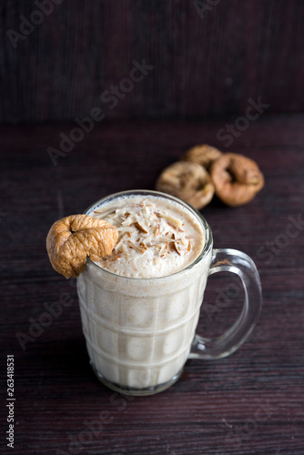 Anjeer milk shake or dried fig milk shake with almonds - selective focus