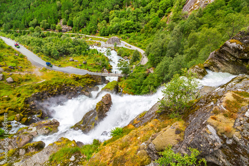 Scenery Waterfall In Briksdal Glacier In Norway. Beautiful waterfall from the meltwater of the Brixdal Glacier in Norway, bottom view. Panoramic view to Kleivafossen waterfall on Briksdalselva river. photo