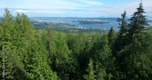 VANCOUVER, CANADA. Aerial view over the sea and mountains by the British Columbia's coast. The metropolitan area surrounded with North Shore Mountains. photo