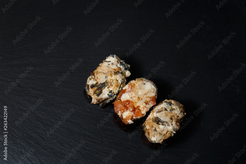 Juicy Gunkan Maki Sushi on black slate Juicy Gunkan Maki Sushi on black slate