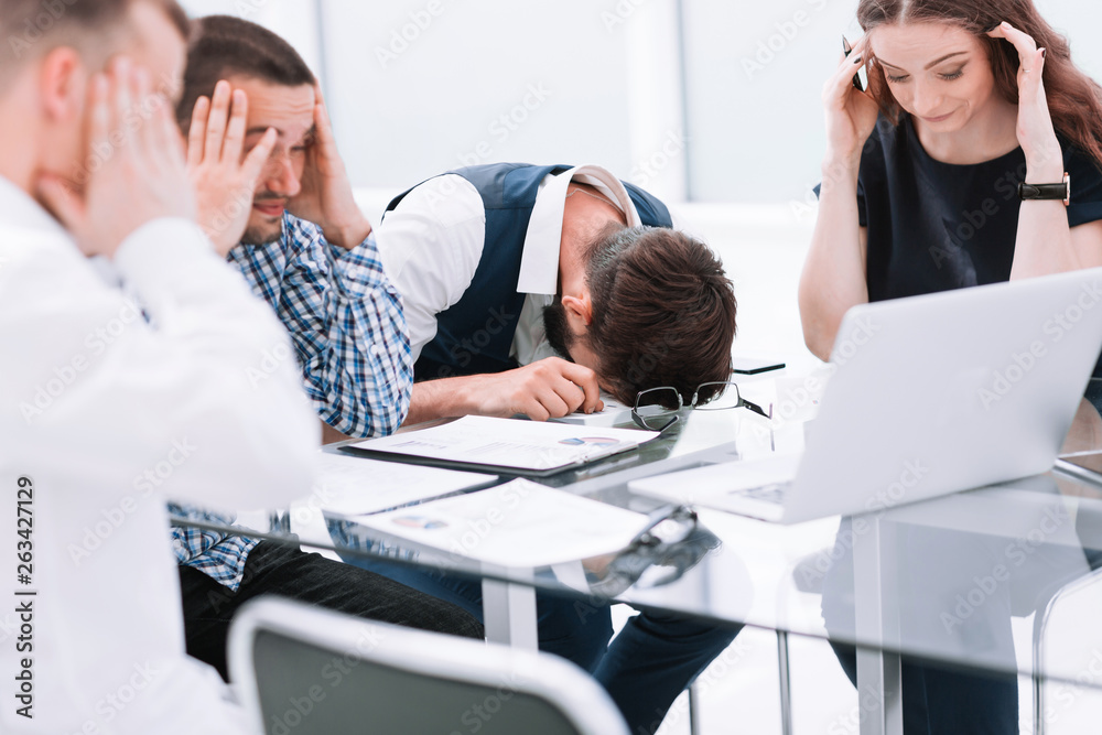 tired business team discussing the problems of a new startup.