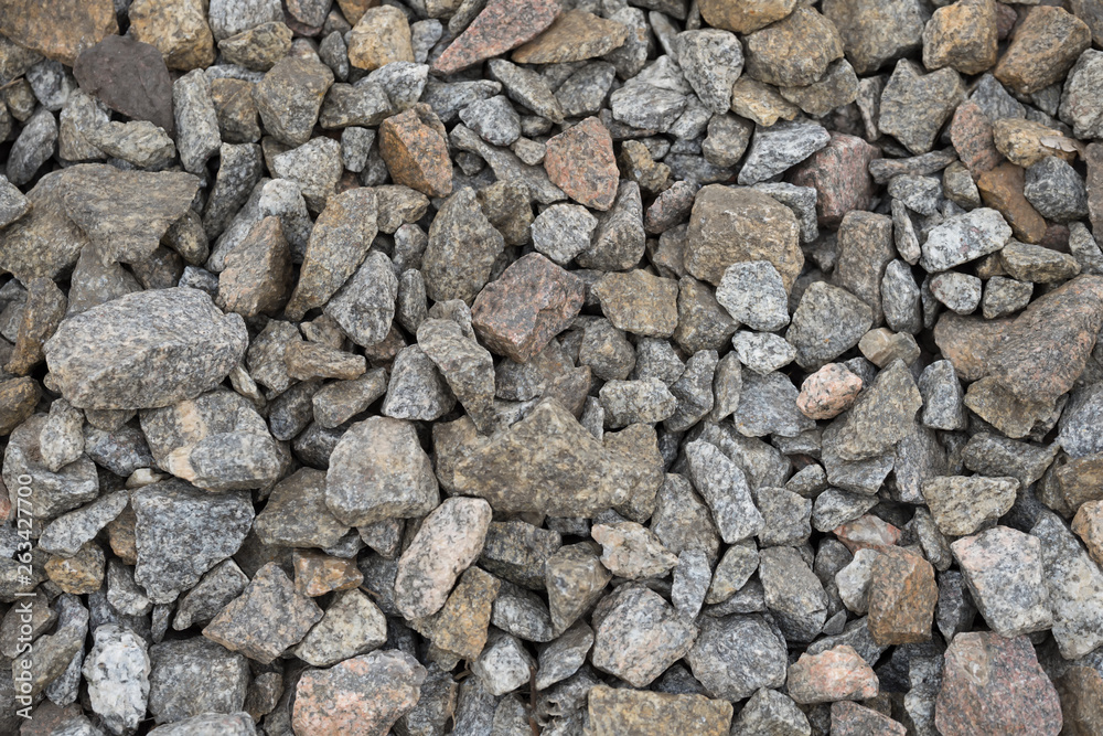 Multi-colored stones on the ground. Different shapes and sizes Multi-colored stones on the ground. Different shapes and sizes