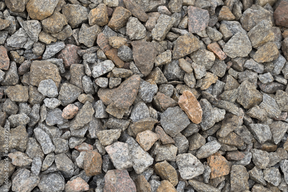 Multi-colored stones on the ground. Different shapes and sizes Multi-colored stones on the ground. Different shapes and sizes