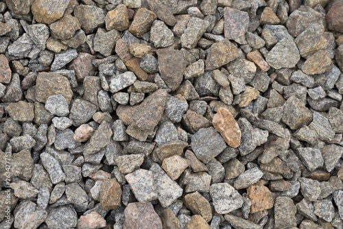 Multi-colored stones on the ground. Different shapes and sizes