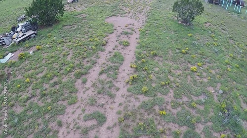 Aerial Fly-Over Of Abandoned Survivalist Bunker And Vehicles- Low photo