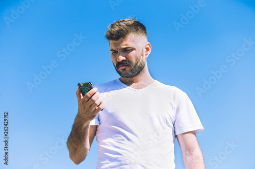 Young man use the phone outdoor. Concept of activity and the availability of mobile connection.