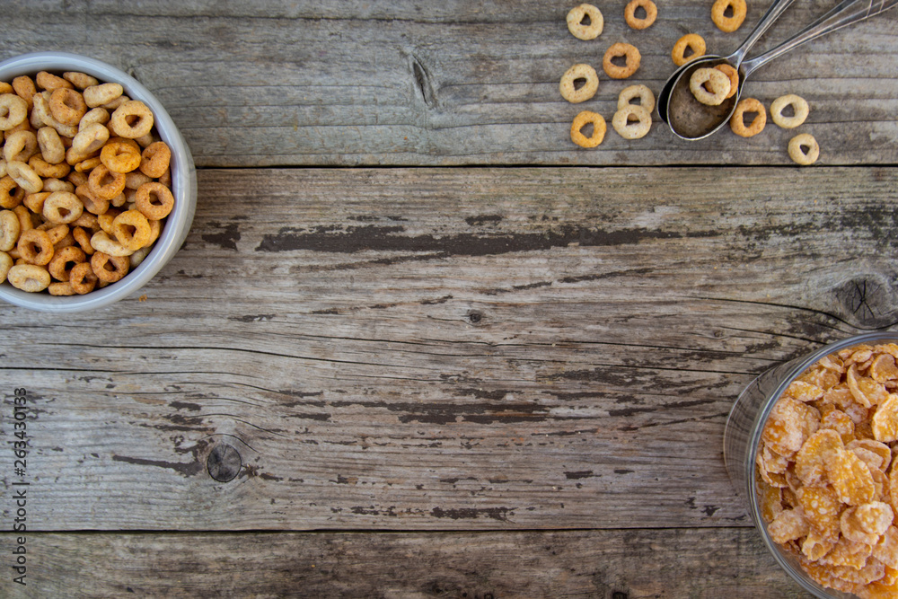 Bowl with corn rings an flakes, cereals breakfast. rustic textured background. Healthy food for kids. Copy space.