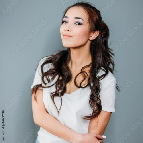 Wallpaper Mural Beauty fashion portrait of smiling sensual asian young woman with dark long hair in white t-shirt on grey background Torontodigital.ca