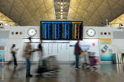 passengers and Tourists checking schedule flying inside of hong kong Airport