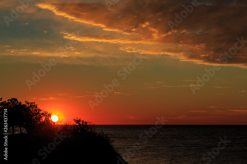 Beautiful red sunset in the Black sea near the resort of Gelendzhik. Red clouds over the steep Bank. Beauty.