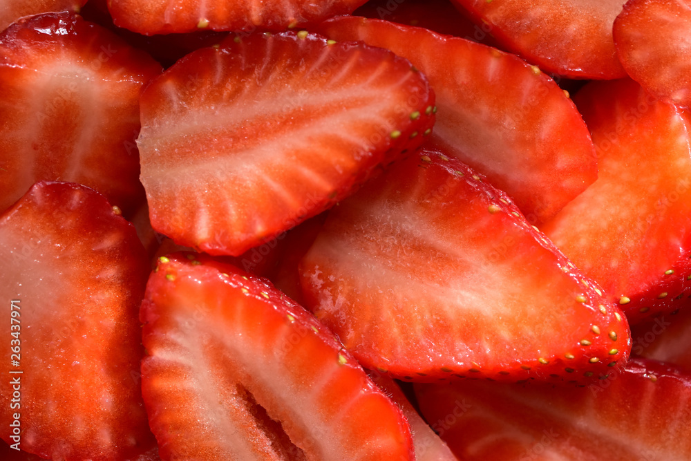 Appetizing texture consisting of sliced ripe summer berries of red strawberry close-up Appetizing texture consisting of sliced ripe summer berries of red strawberry close-up