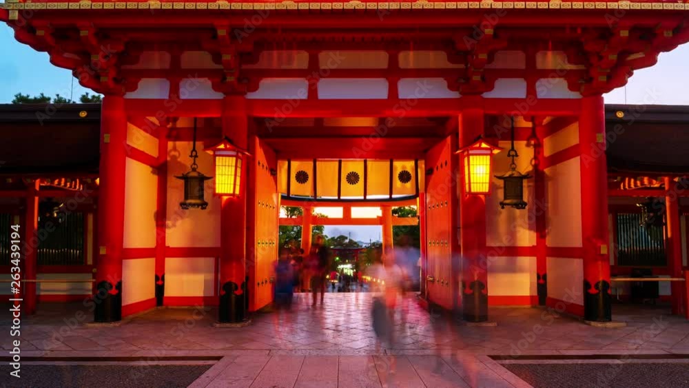 Kyoto, Japan. Main entrance to the Fushimi Inari Taisha shrine in Kyoto, Japan. Time-lapse of motion blurred people in the evening, illumination Kyoto, Japan. Main entrance to the Fushimi Inari Taisha shrine in Kyoto, Japan. Time-lapse of motion blurred people in the evening, illumination