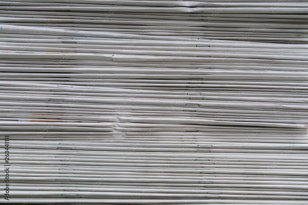 close up newspapers folded and stacked background on the table close up newspapers folded and stacked background on the table