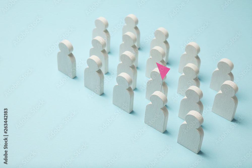 The best employee in the team. Competition, selection for the position. White figures of people on a blue background, business concept. The best employee in the team. Competition, selection for the position. White figures of people on a blue background, business concept.
