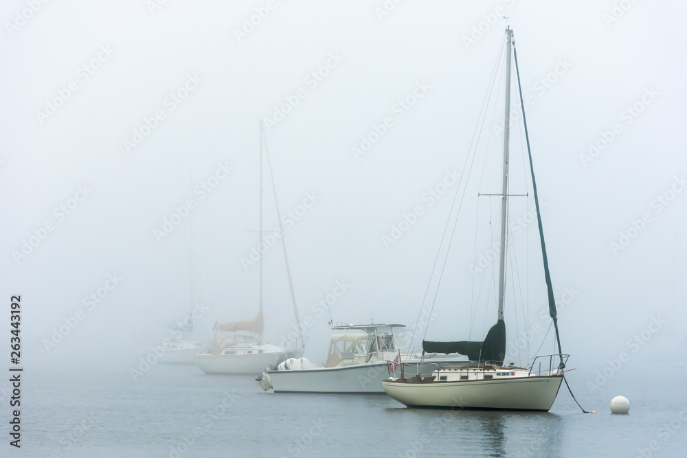 boats at anchor in fog