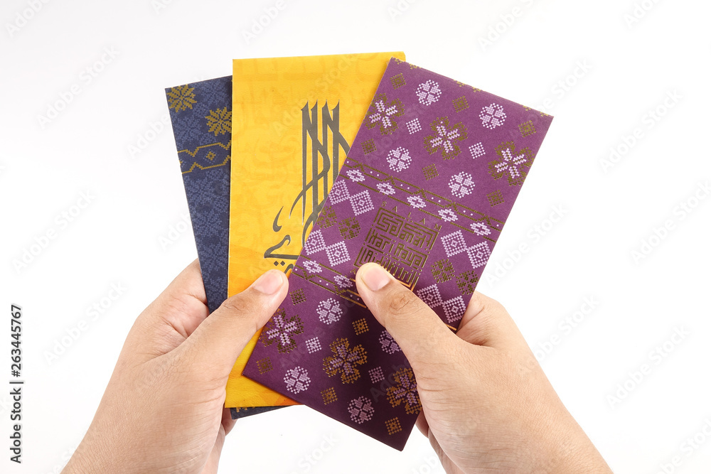Money packet during Eid Fitr on white. Arabic characters means Happy Eid Mubarak.