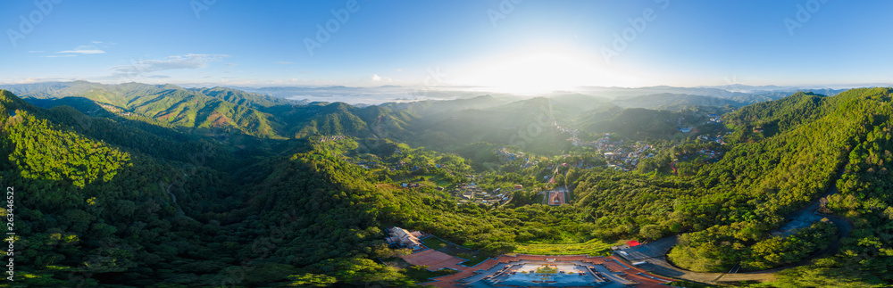 panoramic landscape and over the sunlight with blue sky background on the mountain at morning mist